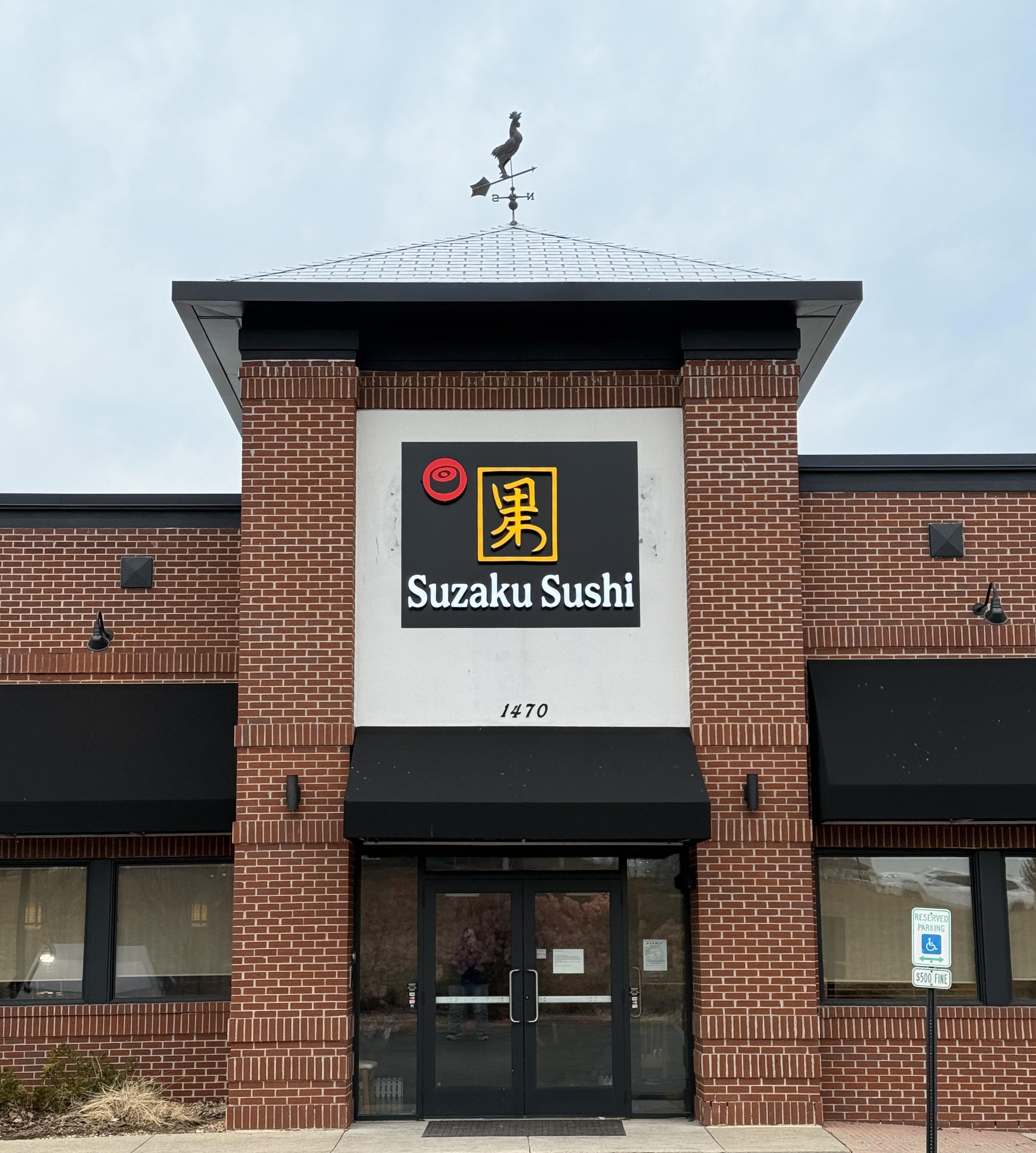 Master sushi chef preparing fresh ingredients at Suzaku Field Sushi Restaurant